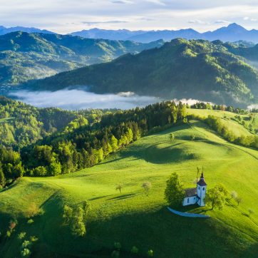 Aerial,View,Of,Slonevian,Hills,With,A,Church,On,The