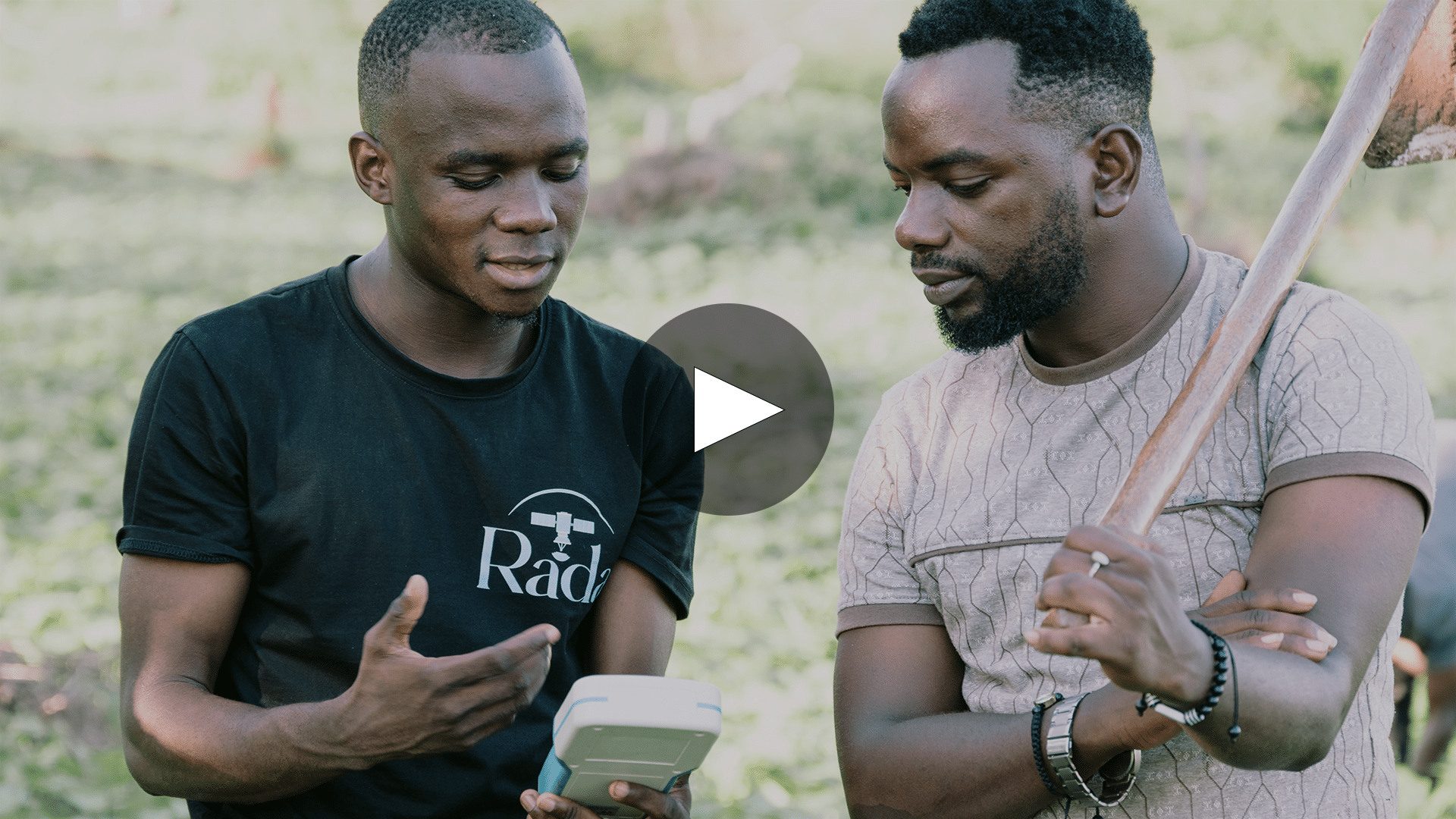 Two farmers discussing over device for AI-powered precision farming