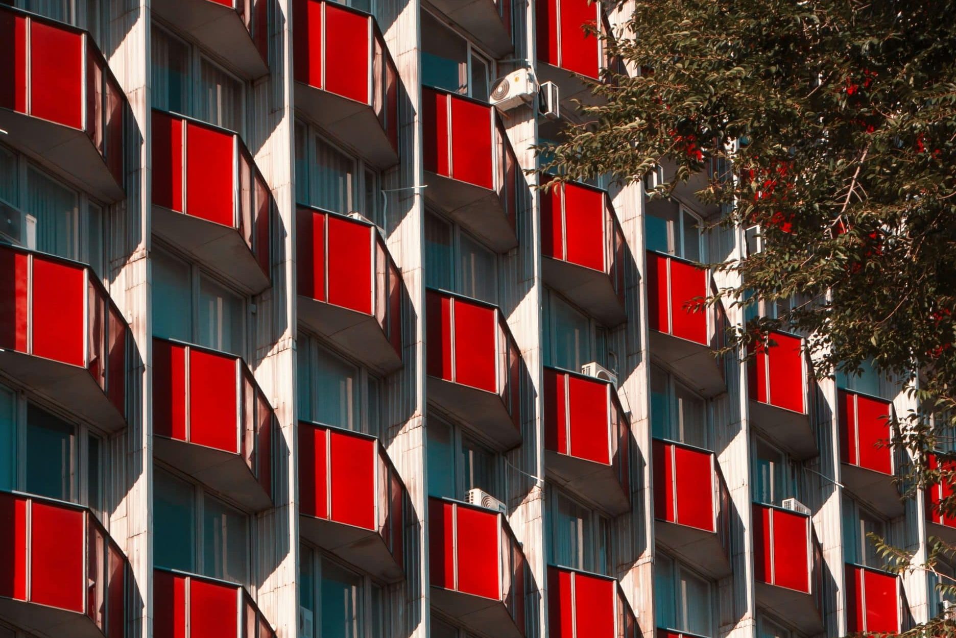 Red balconies adorn the façade of a building in Chișinău, Moldova