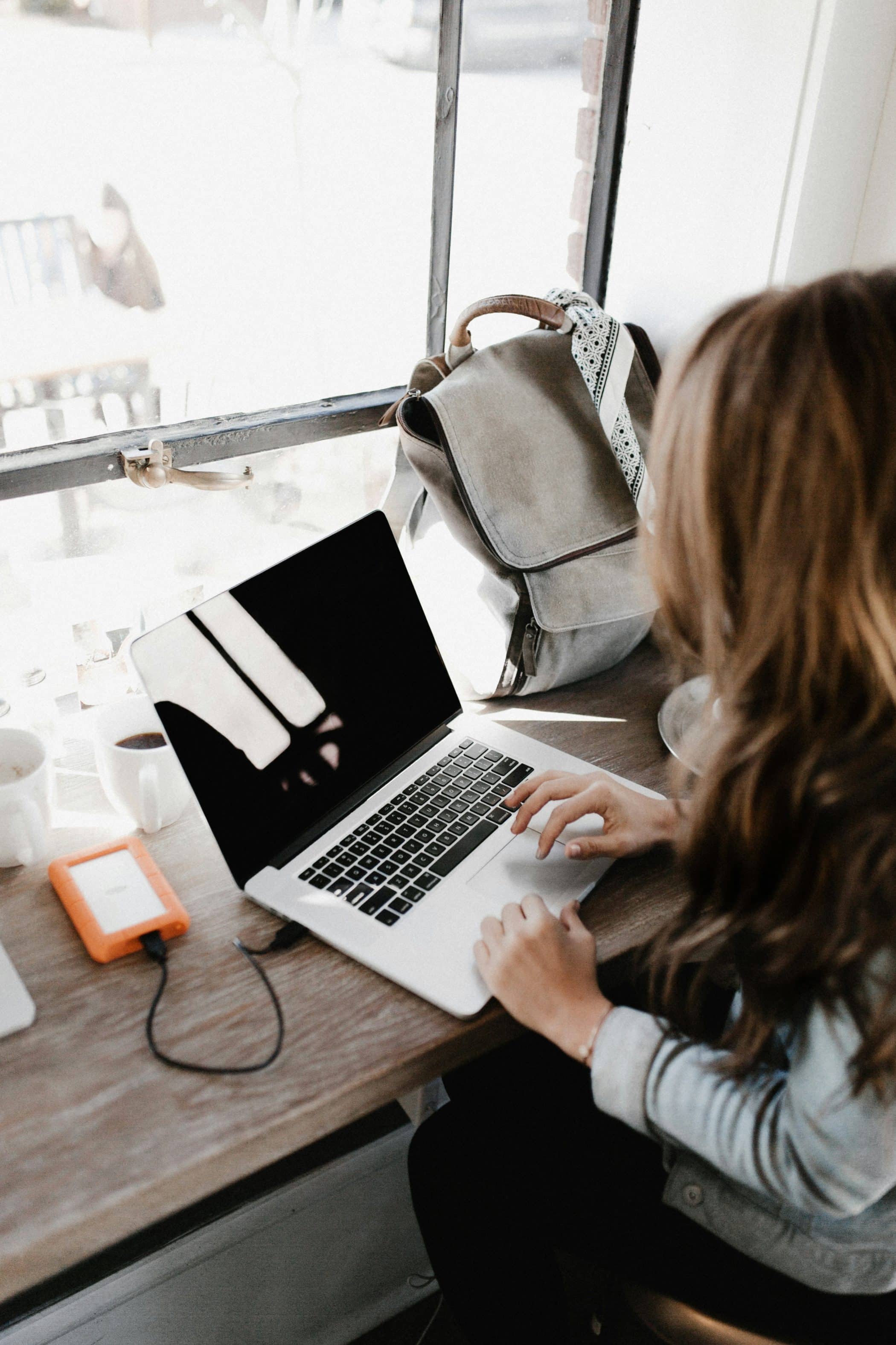 Communications specialist in front of a laptop at a desk